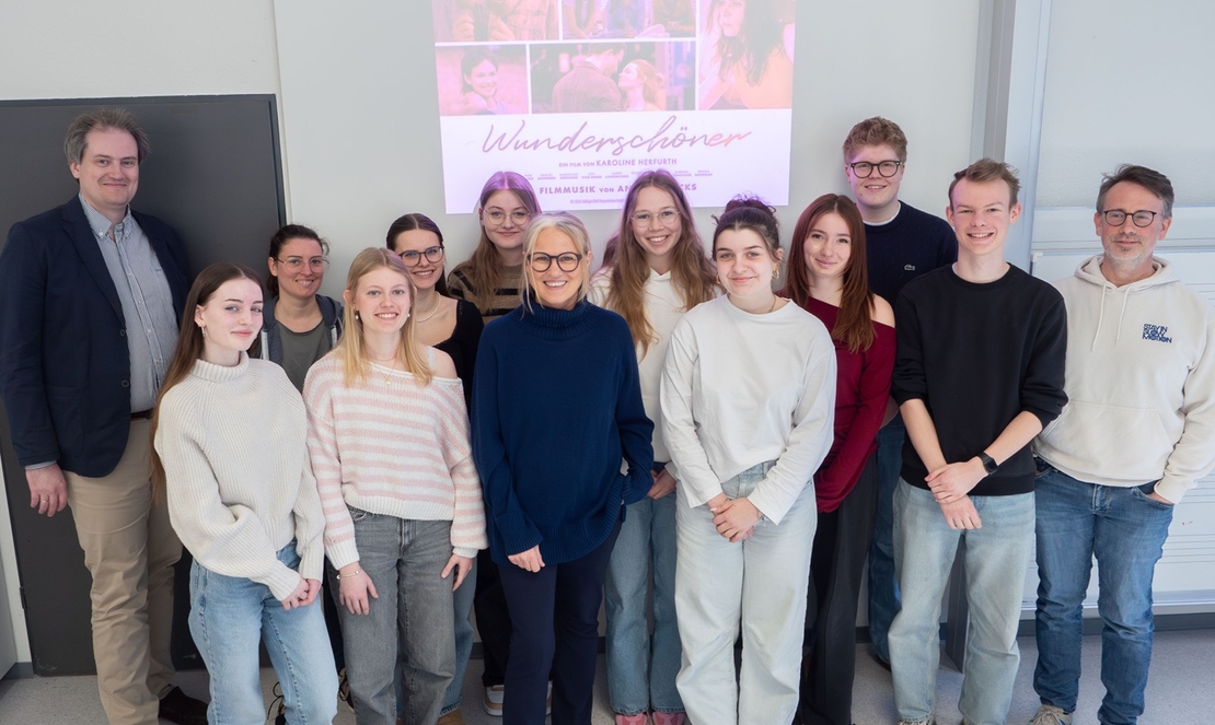 Gruppenfoto von Jugendlichen und Lehrkr&auml;ften in einem Klassenraum.